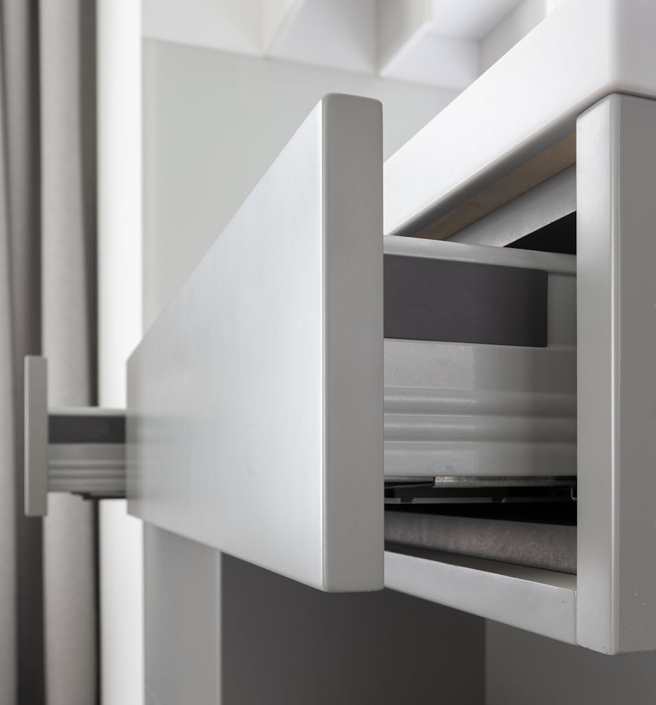 Contemporary expensive cabinet with clean white drawers in modern residential apartment in daytime